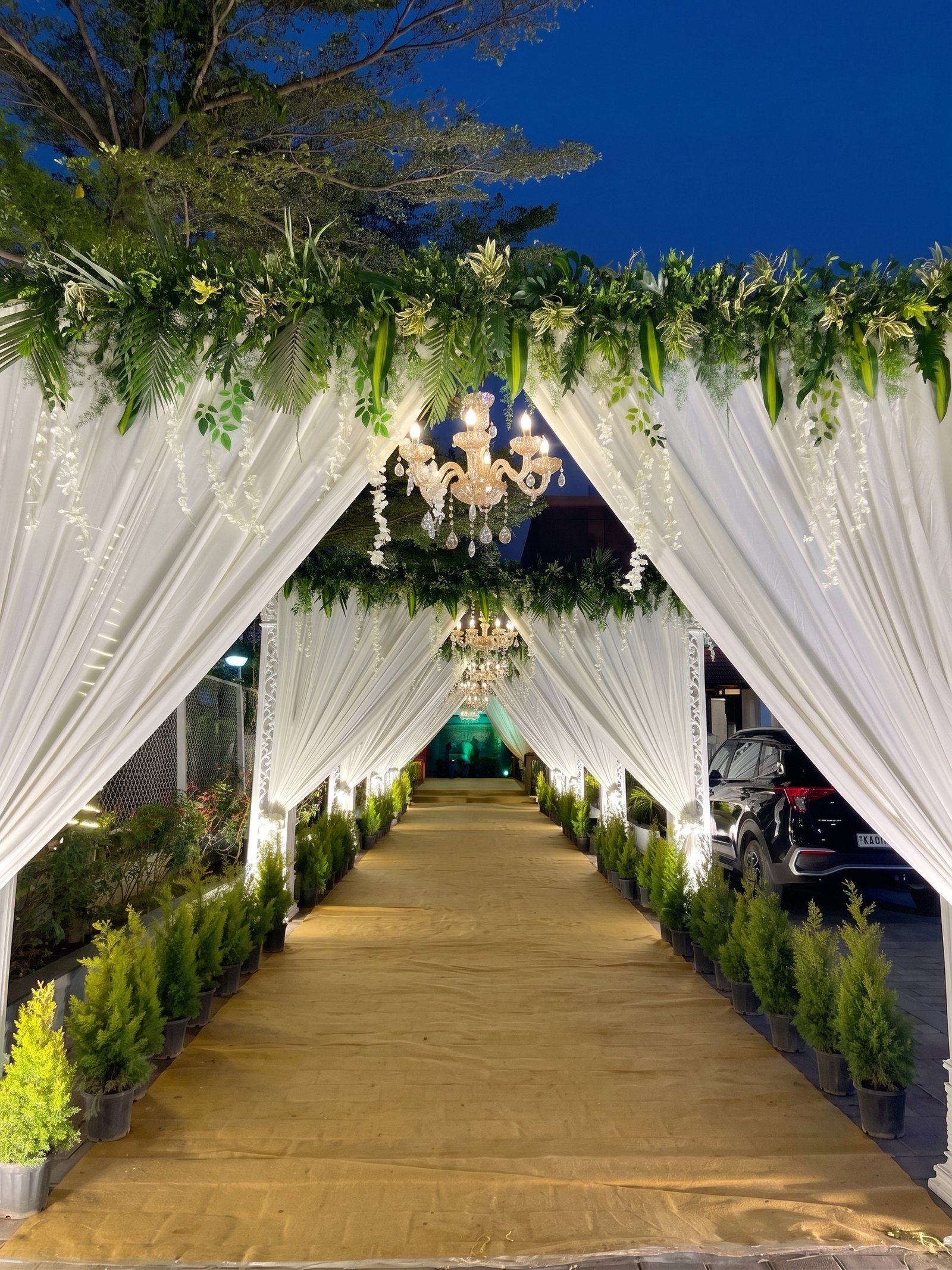 White draped entrance with chandeliers